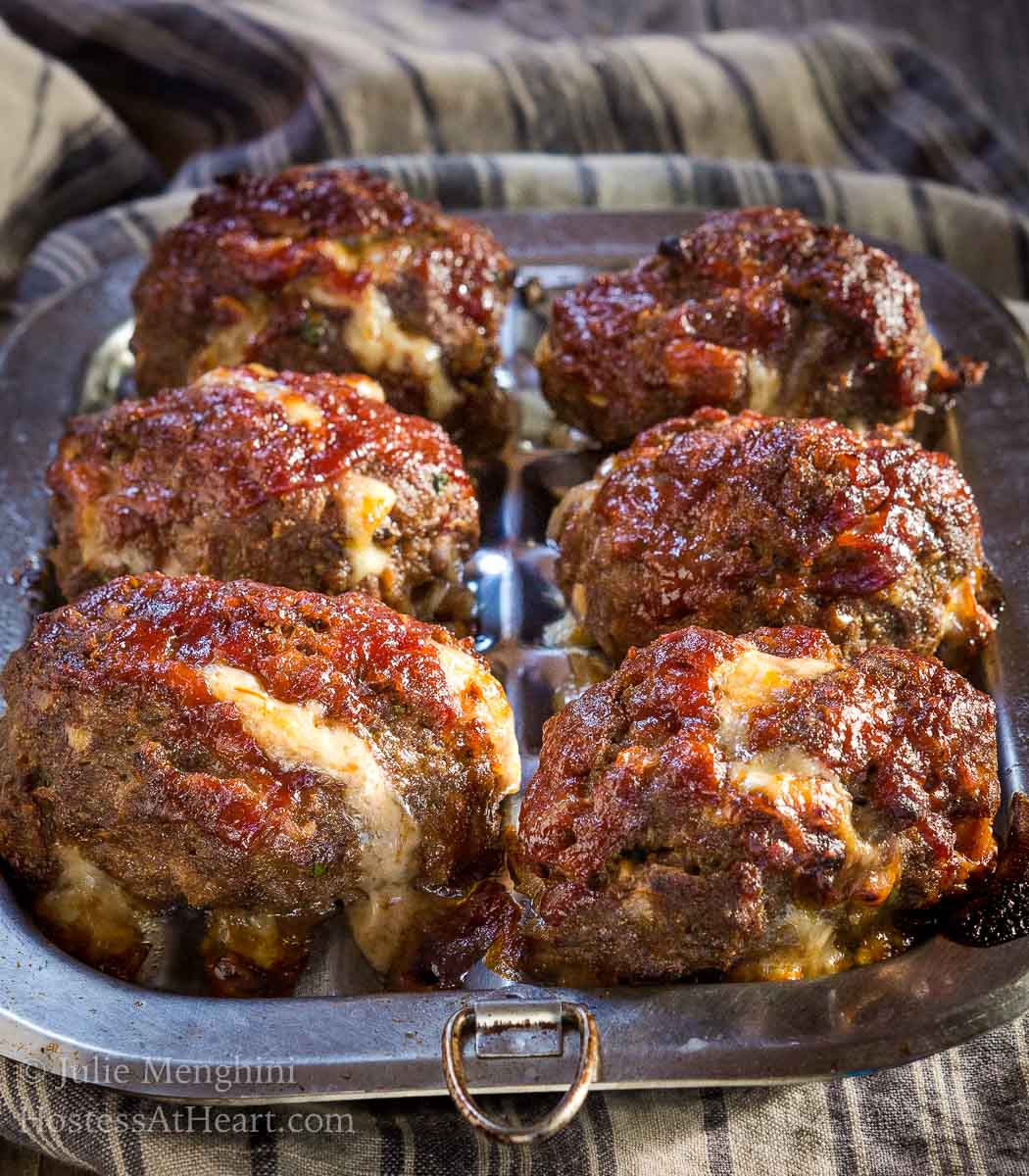 This lightened-up Cheesy Meat Loaf Minis recipe tastes like a decadent rich dish.ย You'll never miss the fat and calories that are missing in this dish. | HostessAtHeart.com Lightened-up Cheesy Meat Loaf Minis