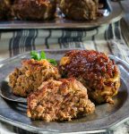 This lightened-up Cheesy Meat Loaf Minis recipe tastes like a decadent rich dish. You'll never miss the fat and calories that are missing in this dish. | HostessAtHeart.com
