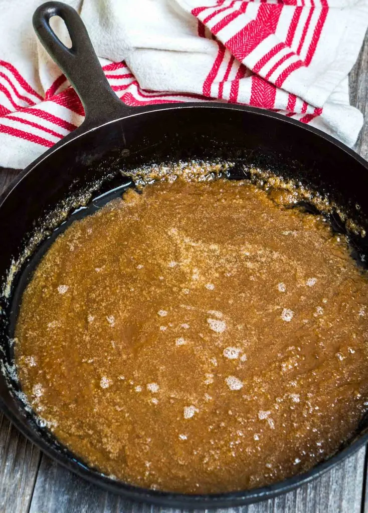 Melted brown sugar and butter in the bottom of a cast iron skillet