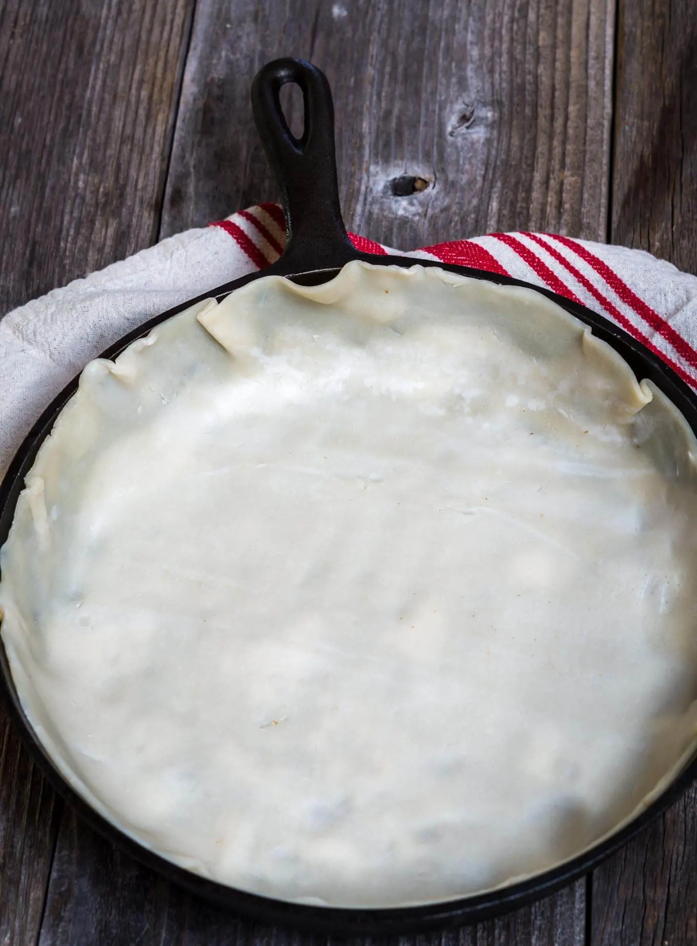 Cast Iron skillet lined with a rolled pie crust