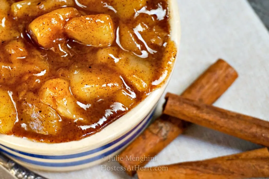 right side of bowl of pear filling with cinnamon sticks