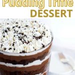 Front view of a trifle bowl filled with layers of cake, pudding and whipped topping.