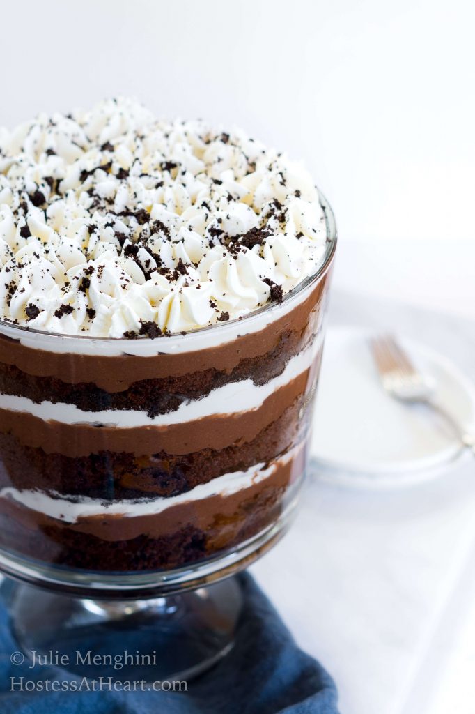 3/4 view of a Chocolate Pudding Trifle with layers of fluffy whipped topping, chocolate cake, chocolate pudding and topped with chocolate cookie crumbs