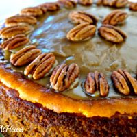 A close up of a Pumpkin Pecan Cheesecake topped with pecans.
