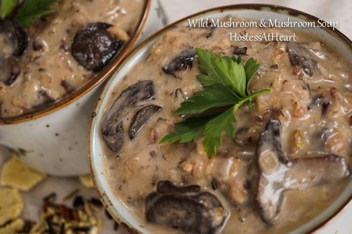 Two soup bowls filled with Wild Rice and Mushroom soup topped with fresh parsley. 