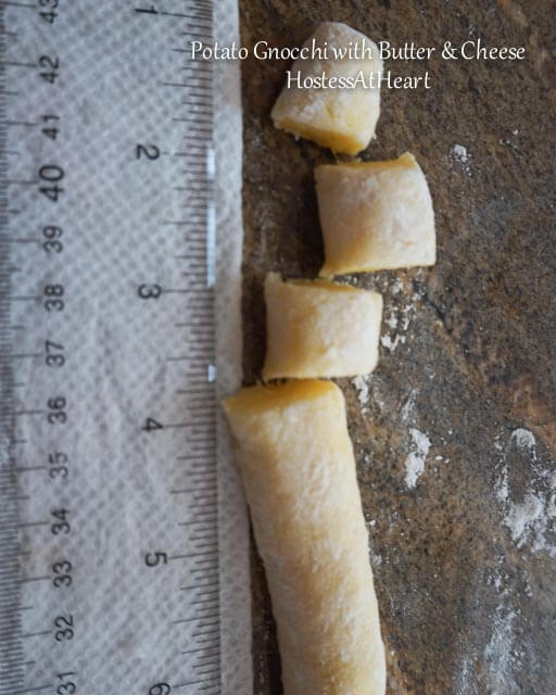 A ruler sitting next to a roll of Gnocchi and 1/2-inch pieces.