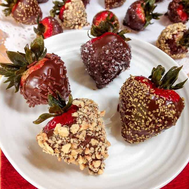 Platter of Vodka infused strawberries dipped in chocolate and sprinkles, nuts, and sugars