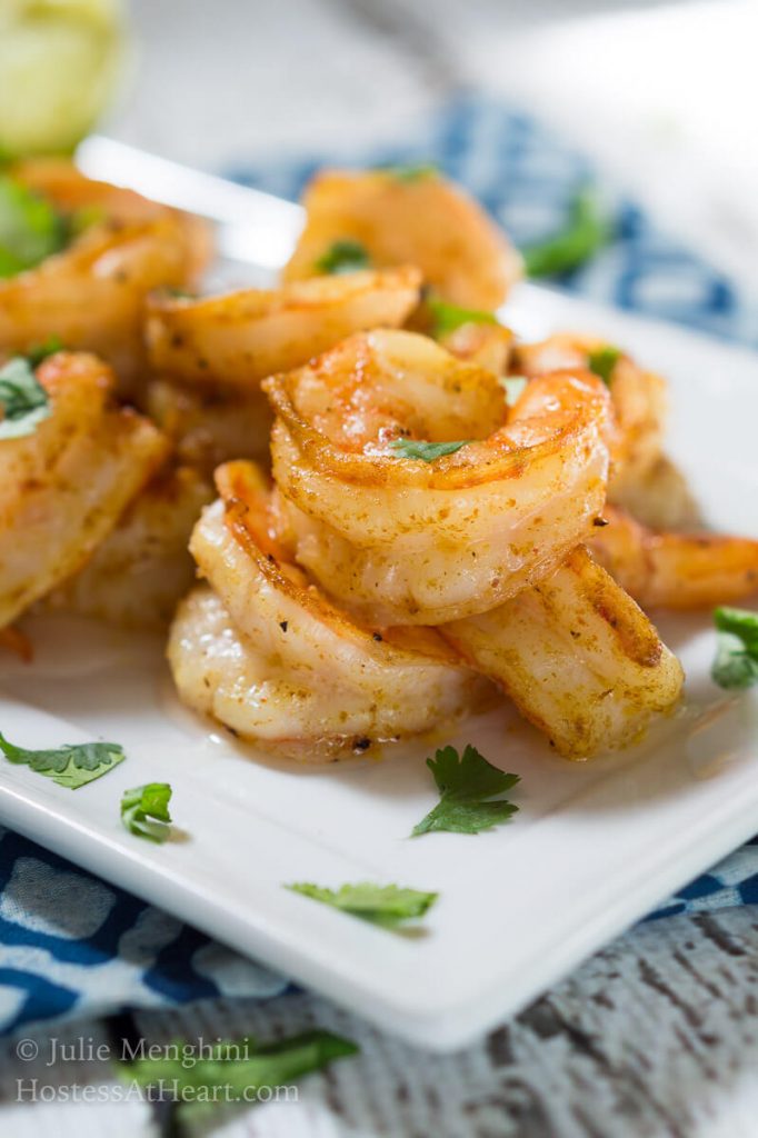 A close up of cooked shrimp garnished with cilantro.