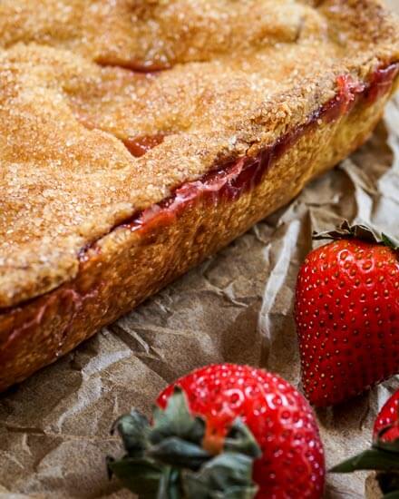 Beautiful and rustic Strawberry Slab Pie has a sweet crunchy, buttery crust that's filled with a delicious thick strawberry filling. - Hostess At Heart