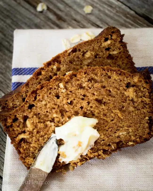 Slices of Applesauce Oatmeal Bread with a dollop of butter.