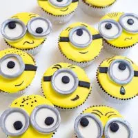 Top-down view of cupcakes decorated to look like minions.