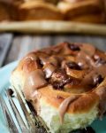 close up of one sweet roll with chocolate malt glaze