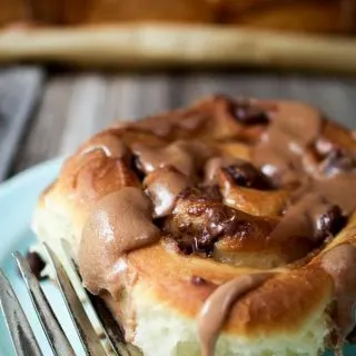 close up of one sweet roll with chocolate malt glaze