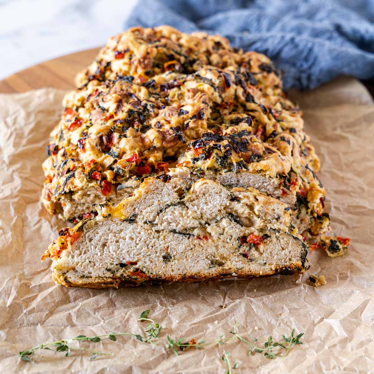 A front view of a sliced loaf of spinach bread.