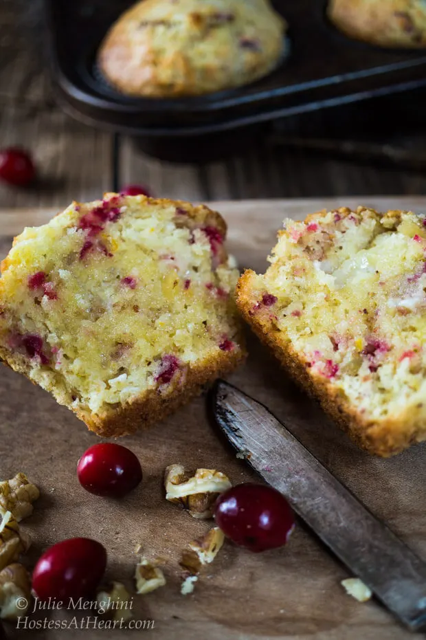 A cranberry-Orange muffin that\'s been cut in half showing it\'s the soft center.