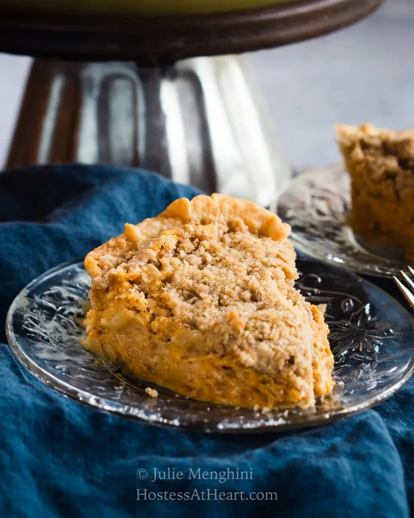 Front view of a slice of pumpkin cheesecake pie