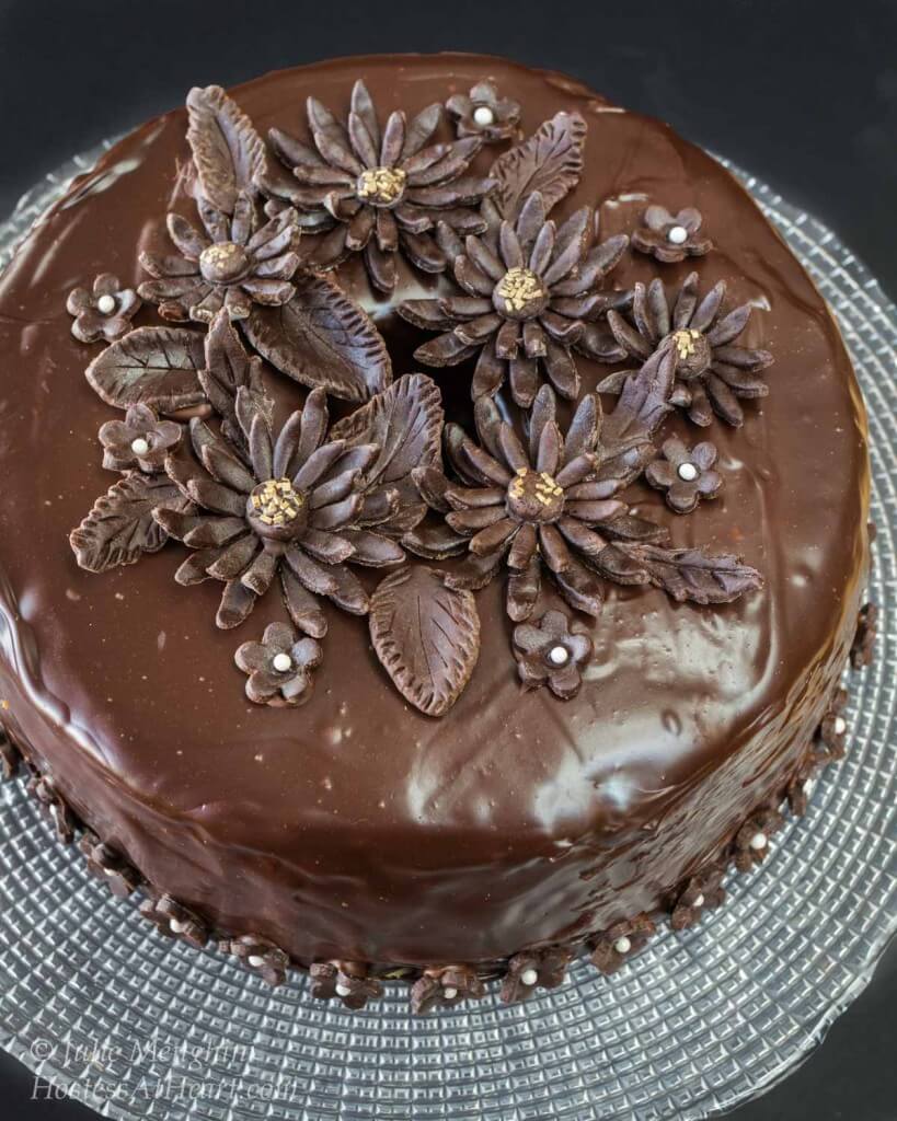 Top view of a beautiful creamy dark chocolate Black Russian Cake decorated with chocolate daisies