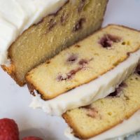 A white plate layered with slices of a Raspberry Swirl Pound Cake.