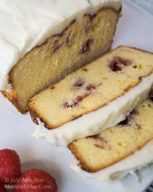 A white plate layered with slices of a Raspberry Swirl Pound Cake.