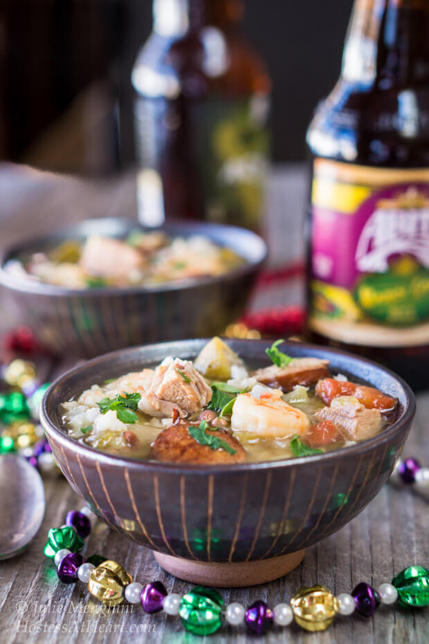 A bowl heaped with shrimp, andouille, and duck in a spicy broth.