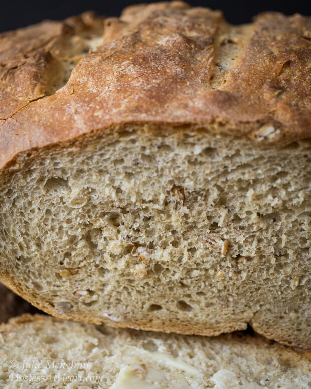 A loaf of bread with the first slice removed showing a soft center.