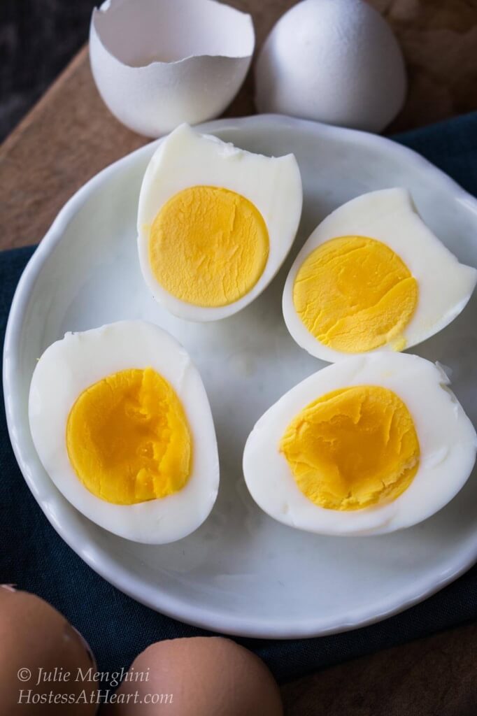 Boiled eggs cut in half on a white plate.