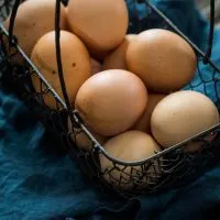 Eggs sitting in a wire basket