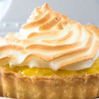 Table view of a pineapple tart topped with meringue