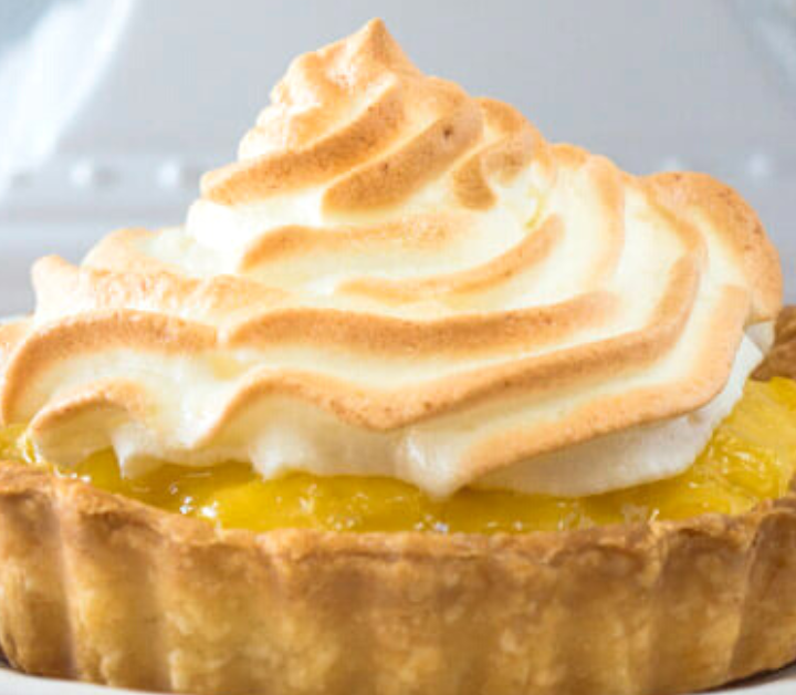 Table view of a pineapple tart topped with meringue