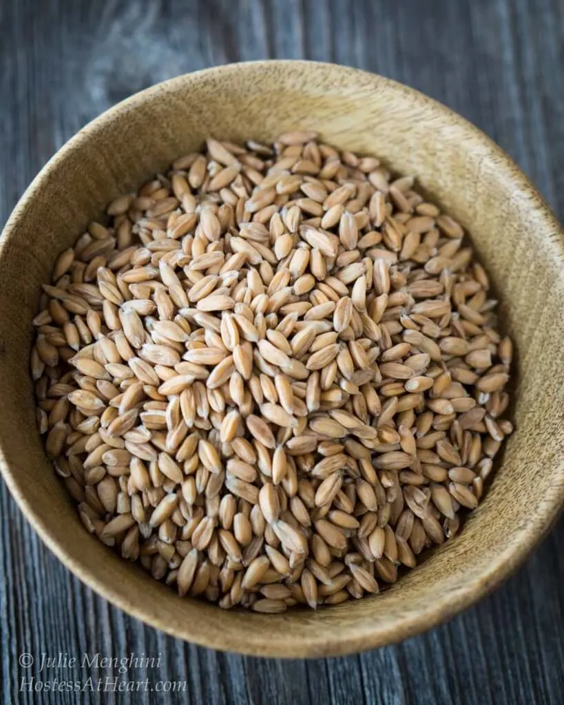 A wooden bowl of spelt grain.