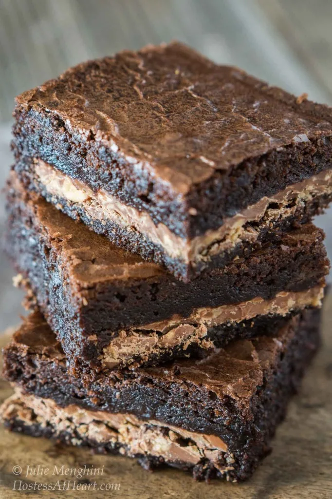 A stack of dark chocolate brownies stuffed with a dark chocolate coffee candy filling.