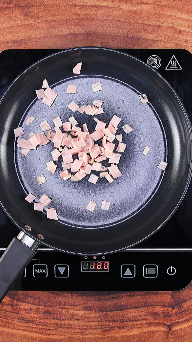 Bacon diced and browning in a skillet