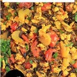 A titled image for Pinterest: A skillet filled with Turmeric Chicken with wild rice, red pepper, onion, celery and garnished with parsley - Hostess At Heart