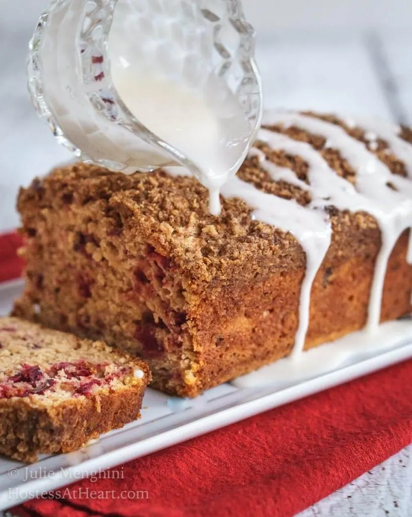 Cranberry Apple Streusel Bread has a delicious soft center dotted with cranberry and apple. This bread is topped with a thick cinnamon brown sugar streusel. | HostessAtHeart.com