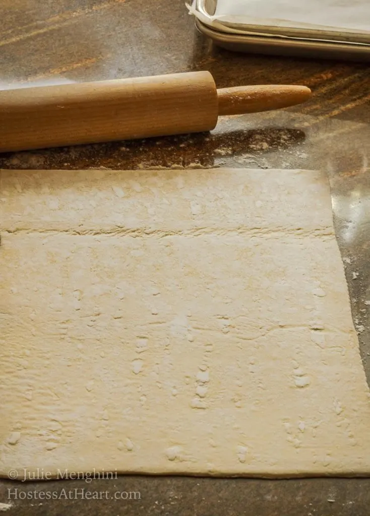 A square of puff pastry rolled out.