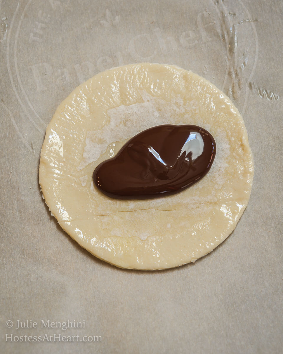 Dark Chocolate Puff Pastry Hand Pies have a light, airy and soft interior enhanced by a deep dark chocolate. The whole thing is wrapped in a golden brown Puff Pastry with a delicate crunch. | HostessAtHeart.com