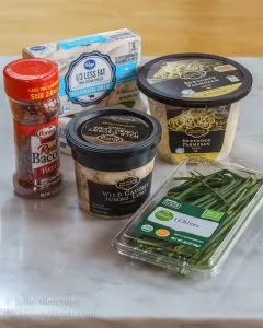 Ingredients used to make Bacon and Crab dip including lump crab, parmesan cheese, cream cheese, bacon, and chives.