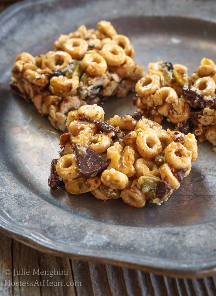 A healthy snack bar made from cereal, honey, and dark chocolate on a metal plate.