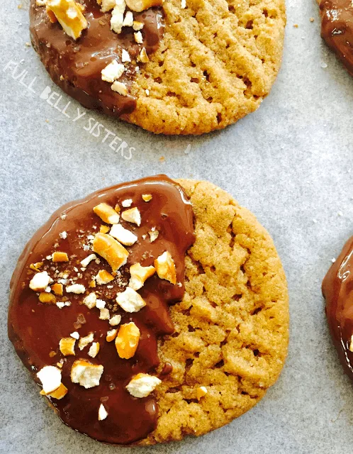 Chocolate Dipped Peanut Butter Cookies sprinkled with crushed pretzels.