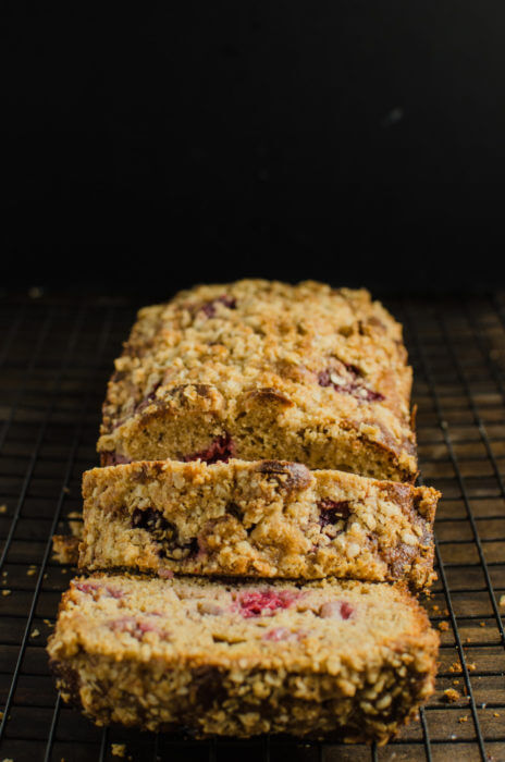 A loaf of Mixed Berry Peanut Butter Streusel Cake sitting on a cooling rack.