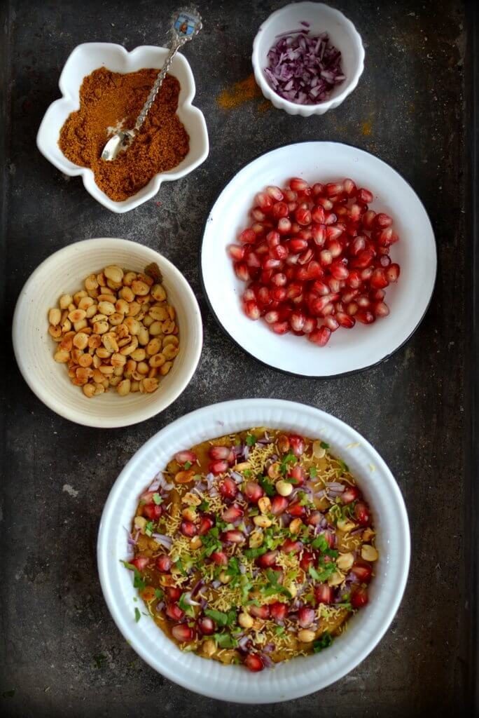 A bowl filled Spice Trail Dabeli Masala and bowls of the ingredients used.