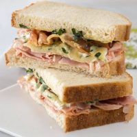 A very special name for a very special sandwich. Ham, Melted Brie, Crispy Prosciutto Sandwich with Basil Aioli is a blend of textures and flavors that will tantalize the taste buds. | HostessAtHeart.com