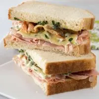A very special name for a very special sandwich. Ham, Melted Brie, Crispy Prosciutto Sandwich with Basil Aioli is a blend of textures and flavors that will tantalize the taste buds. | HostessAtHeart.com