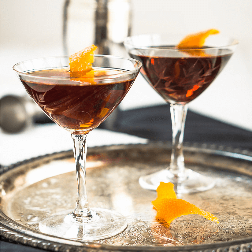 A glass of wine, with Manhattan and Martini