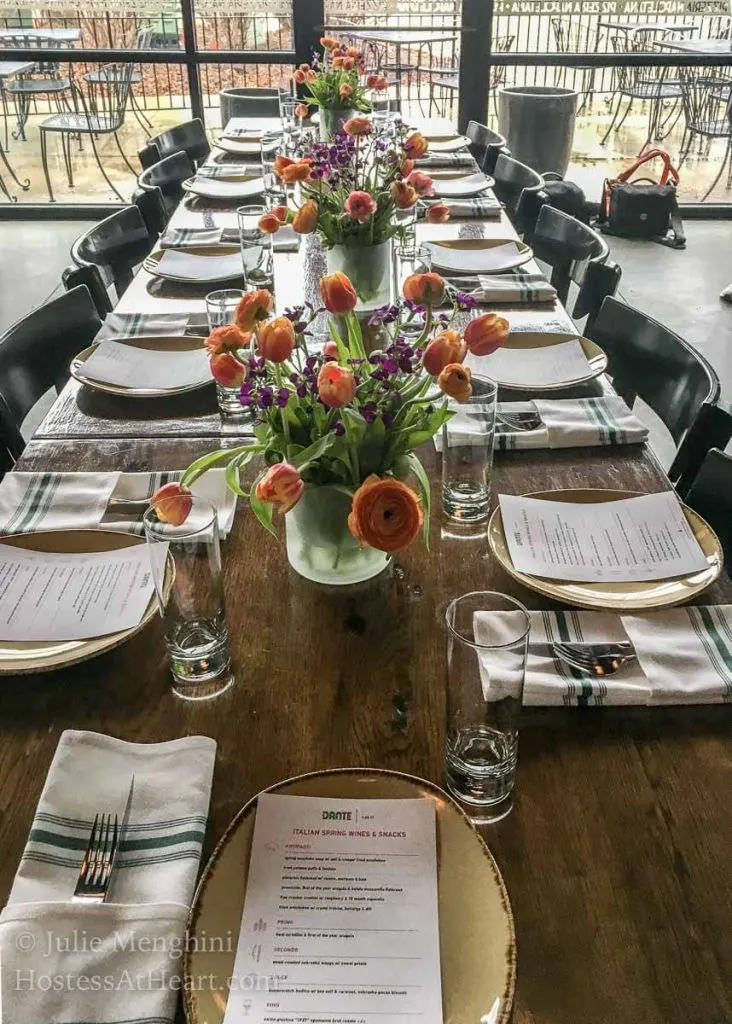 A long wooden table set for guests.