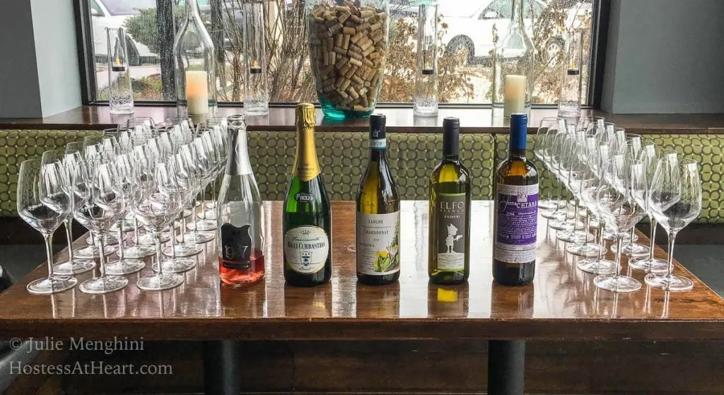 A table filled with bottles of wine.