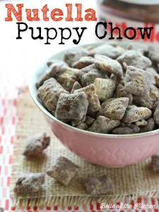 A bowl of puppy chow in a pink bowl with the word \"Puppy Chow\" running across the top.