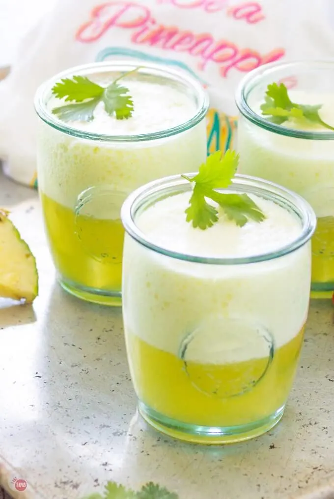 3 glasses filled with a cocktail made from Pineapple, Ginger, and Prosecco.