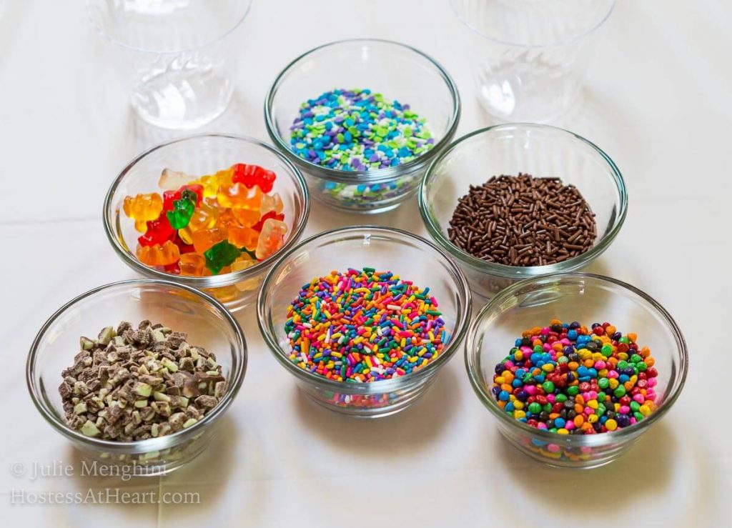 Multiple dishes of multiple colored sprinkles for making Ice Cream Pops.