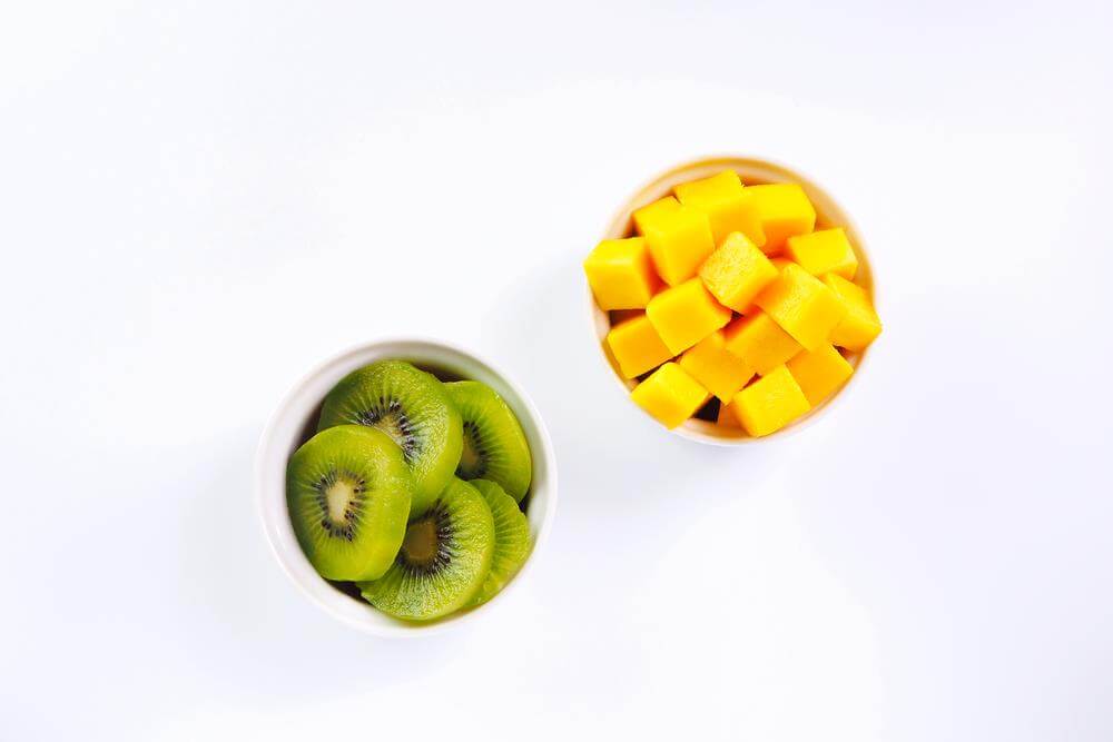 A bowl of fruit, with Mango and Kiwi